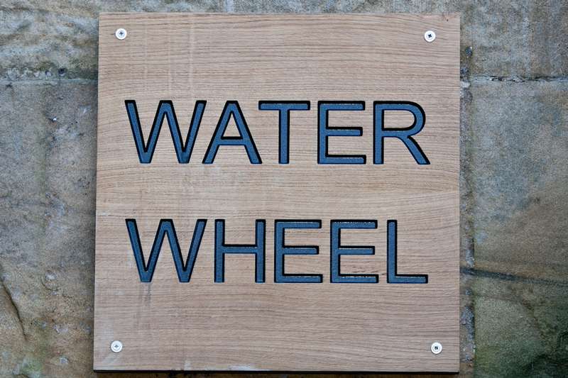 water wheel wall sign
